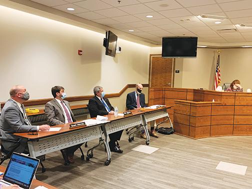 Attorneys for the Putnam County School District, Lex Taylor, far left, and Charlie Douglas, second to left, outline the district’s proposed charter amendment to school board members at a meeting Monday.