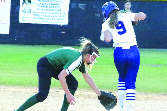 Peniel Baptist Academy’s Summer Langston steals second base in the fourth inning of Thursday’s District 4-2A softball championship game against Daytona Beach Father Lopez High. Shortstop Hannah Wilson tries to pick the ball up. (ANTHONY RICHARDS / Palatka Daily News)