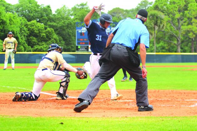 Seminole State catcher Christian Webb puts the tag on the leg of St. Johns River State College’s Jakob Runnels in the fourth inning of Game 2 of the best-of-three Mid-Florida Conference series Sunday. Runnels was called out on the play. (MARK BLUMENTHAL / Palatka Daily News)