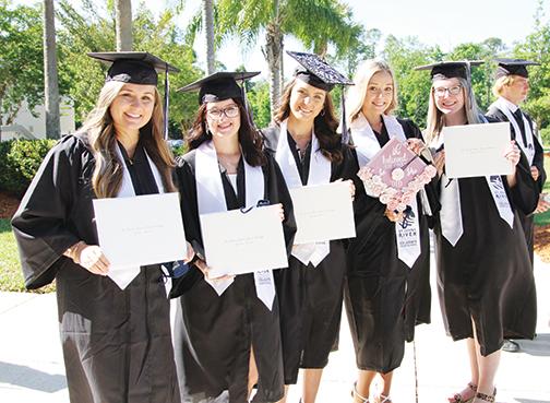 St. Johns River State College graduates who earned their associate degree while attending Palatka High School include McKinzey Williams, Kya Kriser, Josie Bohanan, Savannah Maya and Erin Owens, pictured moments after Friday’s SJR State commencement ceremony.