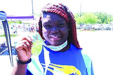Palatka's Torryence Poole shows off her gold medal she won Saturday in the shot put at the FHSAA 2A championship at the University of North Florida. (MARK BLUMENTHAL /Palatka Daily News)