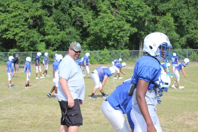 Interlachen High School’s new football coach, Erik Gibson, has a laugh while watching his players go through a drill in practice last week. (MARK BLUMENTHAL / Palatka Daily News)