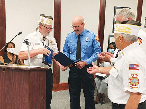 Palatka Fire Department Engineer David Zimmer, center, receives the Firefighter of the Year award from Veterans of Foreign Wars Post 3349 Quartermaster Gerald Shuler, left, and Commander Gerald Donnelly, right.