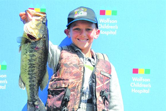 Brooks Anderson holds up a 4-pound bass he caught Saturday. (GREG WALKER / Daily News correspondent)