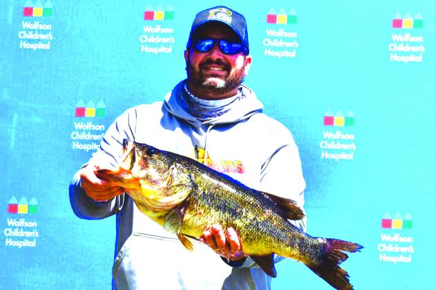 Andrew Pulliam shows off the 9.59-pounder he and partner James Sojka caught for big bass of the tournament. (GREG WALKER / Daily News correspondent)