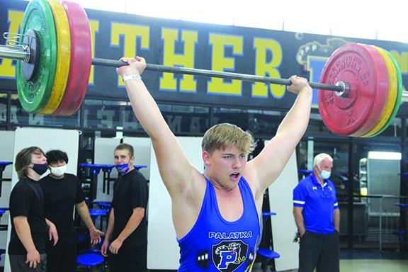 Palatka’s Jack Tilton delivers a successful clean and jerk lift at the Putnam County boys weightlifting championship on March 10 at Palatka High School. (ANTHONY RICHARDS / Palatka Daily News)