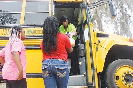 A Putnam County School District employee passes out meals to local students in March 2020 when classrooms were first closed because of the COVID pandemic.