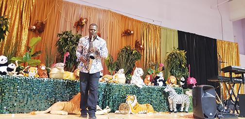 Steven Chandler plays the saxophone on an African-decorated stage Saturday during the Juneteenth Celebration at the Family Life Center.