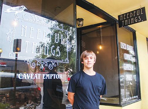 Ethan Sharp stands outside his Palatka storefront Thursday as he takes a break from organizing hundreds of books that have been donated.