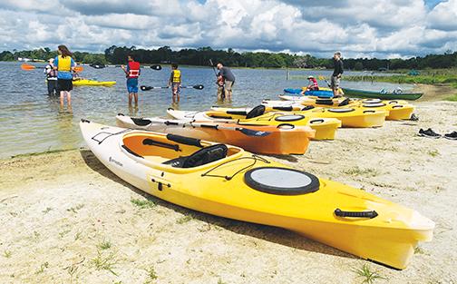 Kayaks line the shore of Lake Stella on Saturday during the Cops, Kids and Kayaks event in Crescent City.
