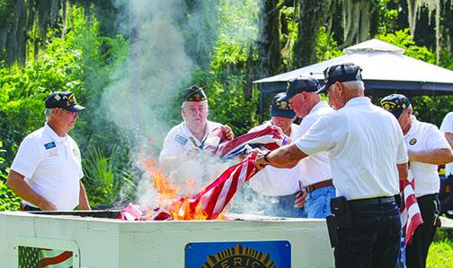 Members of American Legion Bert Hodge Post 45 in Palatka retire American flags Monday during a Flag Day ceremony. 