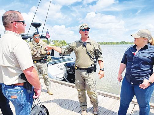 U.S. Rep. Kat Cammack, R-Fla., and Putnam County Sheriff Gator DeLoach talk to Texas Department of Public Safety Highway Patrol Division officers Thursday while learning about the border crisis along the Rio Grande River.