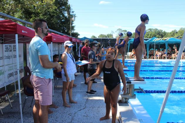Blythe Harvey exits the pool after swimming in the 9-10 division 50-yard girls freestyle. (MARK BLUMENTHAL / Palatka Daily News)