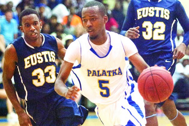 Palatka’s Terance Evans drives to the basket past Eustis’ K.C. Coleman during the FHSAA Region 2-5A championship game. (Daily News file photo)