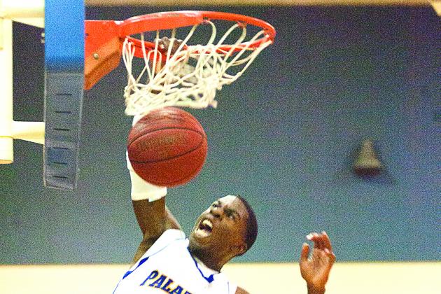 Travis Brown delivers an emphatic fourth-quarter slam dunk against Eustis. (Daily News file photo)