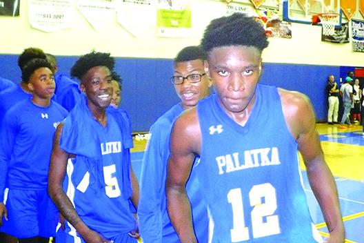 Wesley Roberts (12) and his Palatka High School boys basketball teammates are elated after beating New Port Richey Ridgewood for the regional title. (MARK BLUMENTHAL / Palatka Daily News)