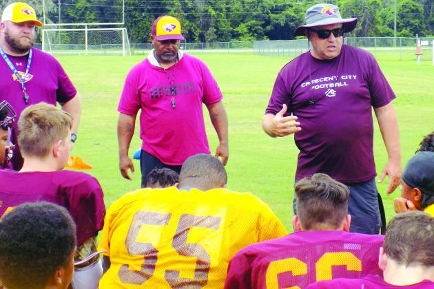 Crescent City High School football coach Sean Delaney (right) talks to his players during practice on Aug. 5. (COREY DAVIS / Palatka Daily News)