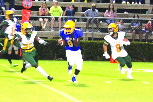 Palatka’s Q’Juan Nelson finds a hole between Yulee defenders Braylen Ricks (left) and Ernest Cortez for a 91-yard touchdown kickoff return to start the game Friday night. (MARK BLUMENTHAL / Palatka Daily News