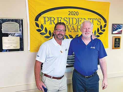 Beck Ford Service Manager Mark Roser stands with salesman Rick Fullerton in front of the dealership’s 2020 Presidents Award, which they received just months before the Platinum Blue award the Palatka dealership was given earlier in August.