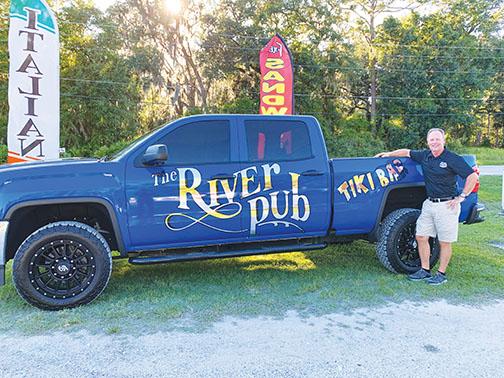 Co-owner Bobby Glaize stands next to a River Pub-styled truck in front of his Georgetown restaurant, Bobby G’s River Pub.