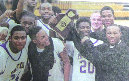 Members of the Palatka High School boys basketball team celebrate their District 4-4A championship with the trophy after beating Palm Coast Matanzas in 2011. (Daily News file photo)
