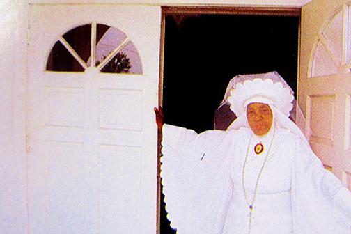 Mother Essie Mae McDonald stands in the doorway of her church. She was featured in a Newsweek book, "A Day in the Life of America," in 1986.
