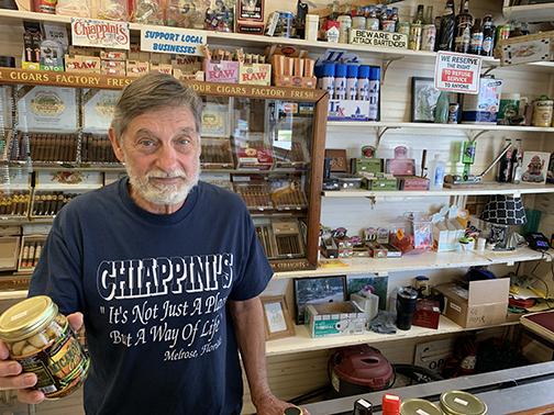 Robin Chiappini, holding a locally made garlic, is a third-generation owner of Chiappini's in Melrose.