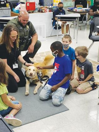 Putnam County Sheriff’s Office K-9 therapy dog Bailey visits with Moseley Elementary School students Monday.