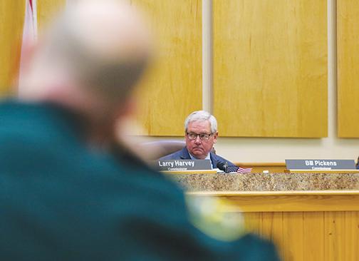 Commissioner Bill Pickens listens during a conversation about the county’s insurance fund deficit during a Board of County Commissioners meeting on Tuesday morning.