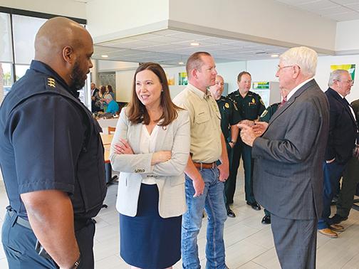 Palatka Police Chief Jason Shaw talks to Moody, with Putnam County Sheriff Gator DeLoach and retired Florida Adjutant General Douglas Burnett in the background.