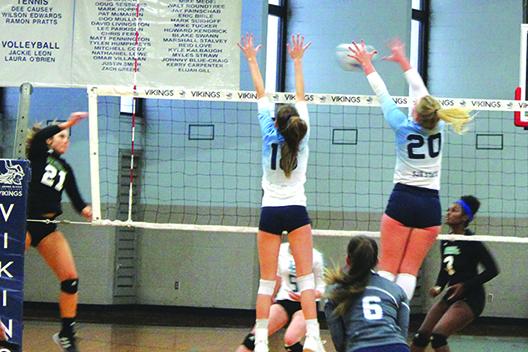 Lake-Sumter’s Madison Heskett (21) gets her kill attempt blocked by St. Johns River State College’s Cassidy Casey (20) for a Vikings point during Tuesday’s Sun-Lakes Conference matchup at Tuten Gymnasium. Also jumping is the Vikings’ Rickie Sheets. (MARK BLUMENTHAL / Palatka Daily News)