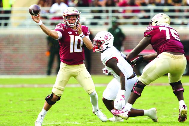 Florida State quarterback McKenzie Milton looks for a receiver during his team’s loss to Louisville last Saturday. (GREG OYSTER / Special to the Daily News)