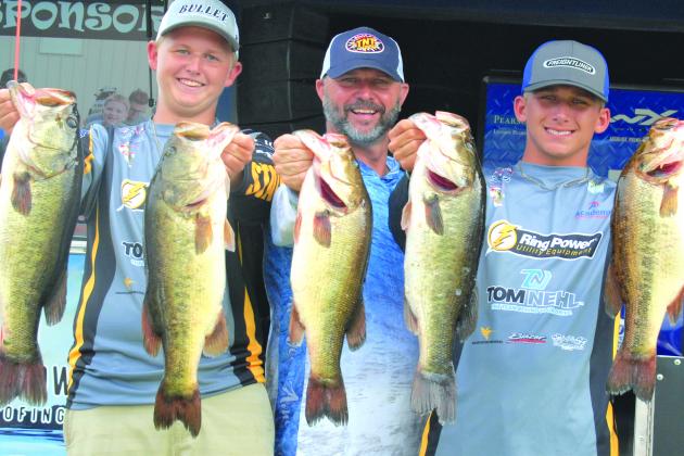 Holding up their winning fish are Parker Stalvey, emcee Glenn Cole and Jason Deel during this past weekend’s Florida B.A.S.S. Nation Junior/High School Fishing event. (GREG WALKER / Daily News correspondent)