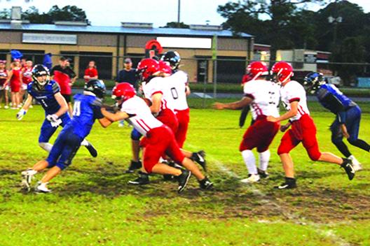 Village View’s Josh David looks to penetrate the offensive line for yards during Friday night’s game at Theobold Sports Complex against Peniel Baptist Academy. (MARK BLUMENTHAL / Palatka Daily News)