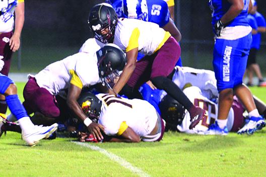 Protected by his teammates, Crescent City’s Josiah Washington (14) comes up with a fumble recovery at the 1-yard line during the first half of Friday’s game at Interlachen. (MARK BLUMENTHAL / Palatka Daily News)