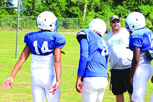Interlachen Junior-Senior High football coach Erik Gibson chats with his players during a May practice. (MARK BLUMENTHAL / Palatka Daily News)