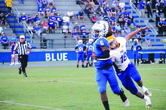 Clay quarterback Jaydan Jenkins tries to get a pass off in front of Palatka’s Optavis Oliver during Friday’s game. (COREY DAVIS / Palatka Daily News)