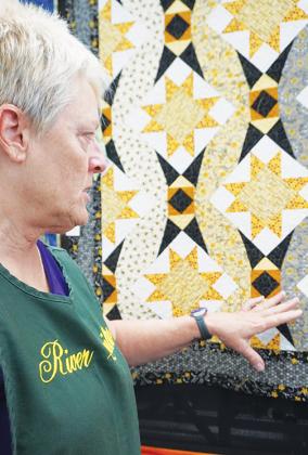 Hawthorne resident Cynthia Irvin stands with her prize-winning quilt, “Honey Bee.”