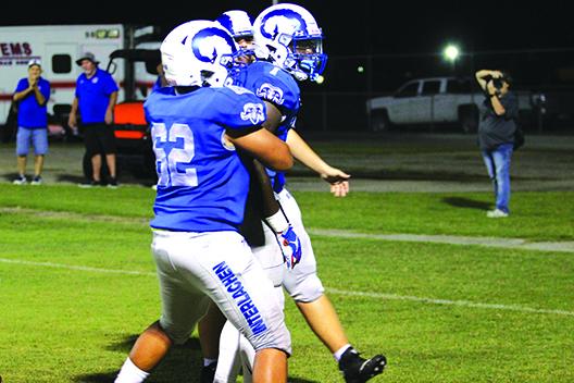 Interlachen quarterback Reggie Allen Jr. (middle) celebrates a second-quarter touchdown with Nathan Jenkins (62) and an unidentified teammate Friday night in a 27-6 victory over Bell. (MARK BLUMENTHAL / Palatka Daily News)