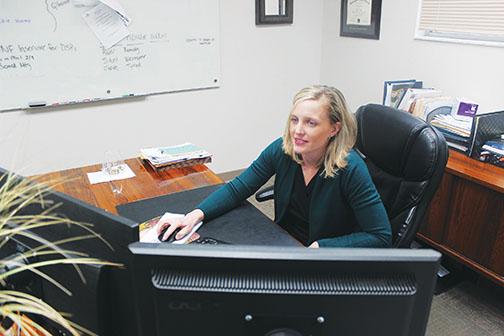 Kari Bates, the outgoing executive director of the Arc of Putnam County, checks emails in her office in Palatka.