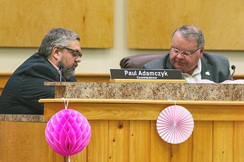 County Commissioners Paul Adamczyk, left, and Terry Turner discuss redistricting during a workshop Tuesday.