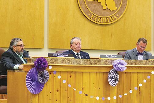 County Commissioner Terry Turner, center, talks about redistricting maps during a board meeting Tuesday as Commissioners Paul Adamczyk, left, and Larry Harvey, right, listen.