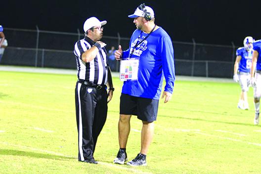 Rams coach Erik Gibson, who won his first career game as a head coach, tries to make a point to the official after a penalty against his team. (MARK BLUMENTHAL / Palatka Daily News)