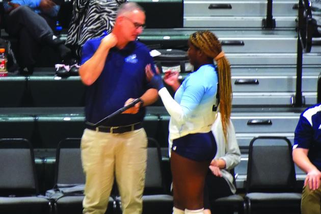 St. Johns River State College volleyball coach Matt Cohen (left) talks strategy with Kendall Hatchett during Thursday’s victory over Palm Beach State. (COREY DAVIS / Palatka Daily News)