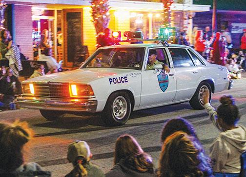 A vintage police car rides in the Christmas parade.