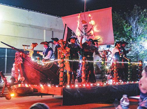 A band of pirates ride a float during the Christmas parade.