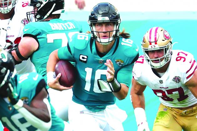 Jacksonville Jaguars quarterback Trevor Lawrence scrambles out of danger during Sunday’s 30-10 loss to the San Francisco 49ers. (JOHN STUDWELL / Special to the Daily News