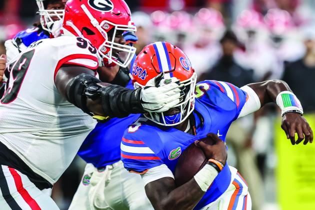 Georgia’s Jordan Davis wraps his hand over Florida quarterback Emory Jones’ helmet and eyes during a run in Saturday’s 34-7 Bulldogs victory over the Gators at T.I.A.A. Bank Field.  (JOHN STUDWELL / Special to the Daily News)