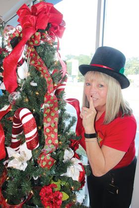 Daley takes a break from decorating one of the trees that will be raffled off to benefit the service center.