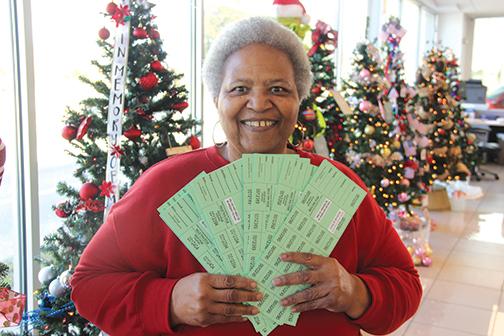 Sheila McCoy, center, executive director of the Palatka Christian Service Center, holds tickets to be sold for people who want to win one of 20 Christmas trees.